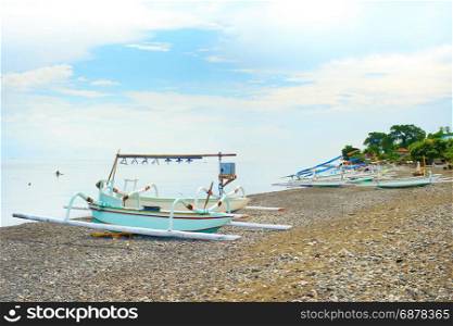 Traditional Balinese boats on a rocky beach. Amed, Bali island, Indonesia