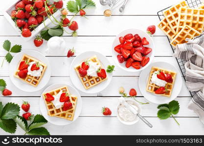 Traditional belgian waffles with cream cheese and fresh strawberry on white background