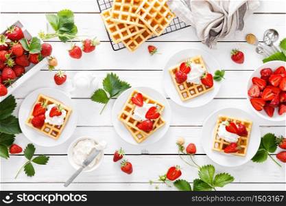 Traditional belgian waffles with cream cheese and fresh strawberry on white background