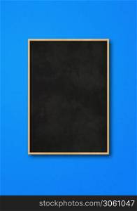 Traditional black board isolated on a blue background. Blank vertical mockup template. Traditional black board isolated on a blue background