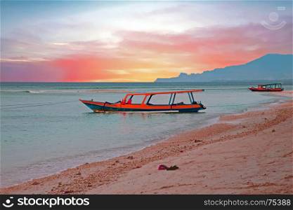 Traditional boat on Gili Meno beach in Indonesia, Asia at sunset