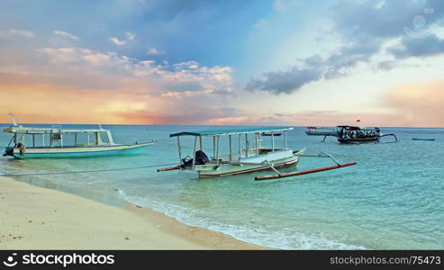 Traditional boats on Gili Meno beach in Indonesia, Asia at sunrise