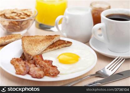 traditional breakfast with fried egg and bacon