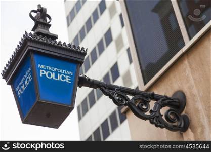 Traditional British Metropolitan Police lamp sign outside police station, London, England