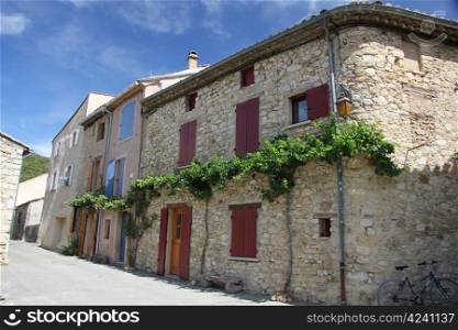 Traditional built houses with doors painted in bright colors in the French Provence