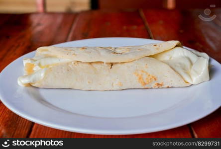 Traditional cheese dish with pickled onion and cream. Traditional Cheese with Pickled Onion,  Concept of typical foods of latin america