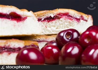 traditional cherry cake made from wheat flour and berries of red cherry jam, cut into pieces. traditional cherry cake
