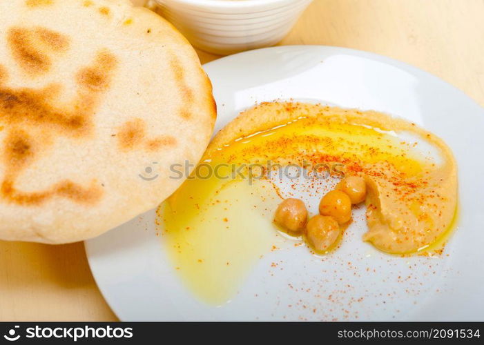 traditional chickpeas Hummus with pita bread and paprika on top