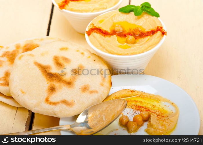 traditional chickpeas Hummus with pita bread and paprika on top