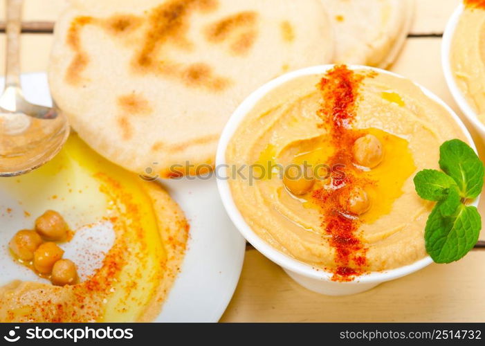 traditional chickpeas Hummus with pita bread and paprika on top