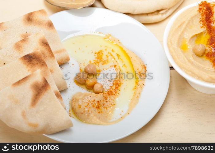 traditional chickpeas Hummus with pita bread and paprika on top