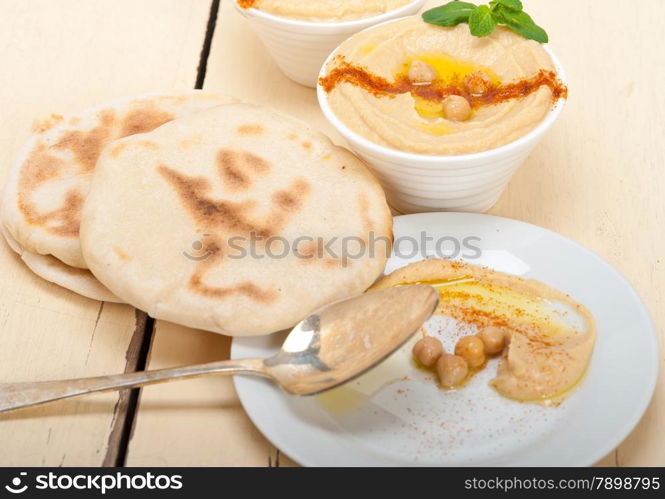 traditional chickpeas Hummus with pita bread and paprika on top