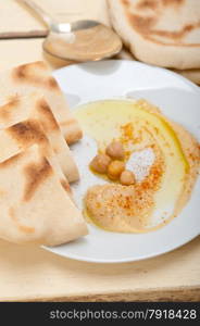 traditional chickpeas Hummus with pita bread and paprika on top