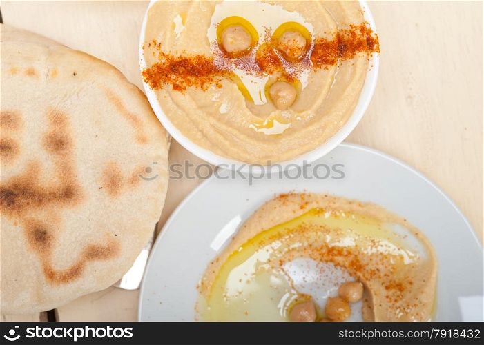traditional chickpeas Hummus with pita bread and paprika on top