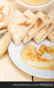 traditional chickpeas Hummus with pita bread and paprika on top