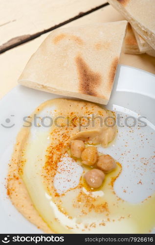 traditional chickpeas Hummus with pita bread and paprika on top