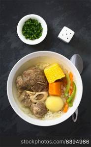 Traditional Chilean Cazuela de Vacuno or Cazuela de Carne, a beef soup with potato, corn, pumpkin, carrot, bell pepper, onion and rice, photographed overhead on slate with natural light. Chilean Cazuela de Vacuno or Carne, Beef Soup