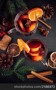 Traditional Christmas hot mulled wine. Hot drink with spices in glass cup on a dark background.. Traditional Christmas hot mulled wine. Hot drink with spices in glass cup on dark background.