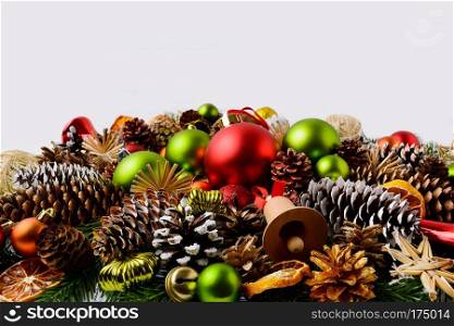 Traditional Christmas ornaments, fir branches and pine cones. Christmas decoration with baubles and dried orange slices. Christmas greeting background. Copy space.