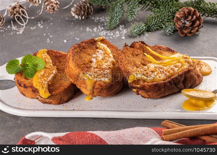 Traditional Christmas Rabanadas with egg yolk cream and cinnamon. Spanish Torrijas close up on the countertop