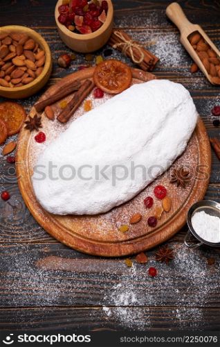 Traditional Christmas stollen cake recipe with ingredients on wooden background. High quality photo. Traditional Christmas stollen cake recipe with ingredients on wooden background