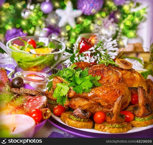Traditional Christmas table on decorated Xmas tree background, delicious roasted chicken with baked vegetables, New Year festive table setting