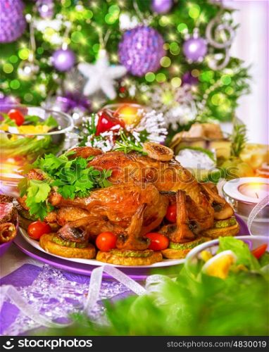 Traditional Christmas table on decorated Xmas tree background, delicious roasted chicken with baked vegetables, New Year festive table setting