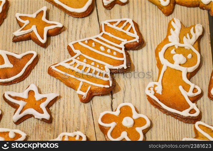 Traditional Christmas treat. Tasty gingerbread cookies on wooden background. Homemade Christmas cookies