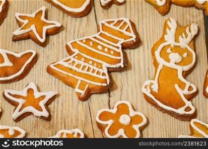 Traditional Christmas treat. Tasty gingerbread cookies on wooden background. Homemade Christmas cookies