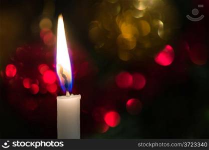 Traditional Christmas tree candle, shining ornaments on background