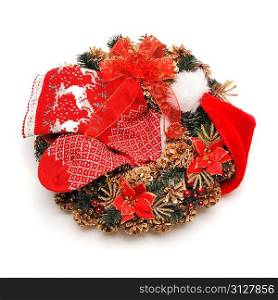 Traditional christmas wreath with santa hat an stocking isolated on white