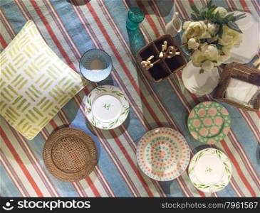 Traditional Classic Picnic Blanket Scene Set out with plates, cushions and cutlery