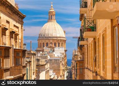 Traditional colorful wooden balconies, Malta. The traditional Maltese colorful wooden balconies and Our Lady of Mount Carmel in Valletta, Malta