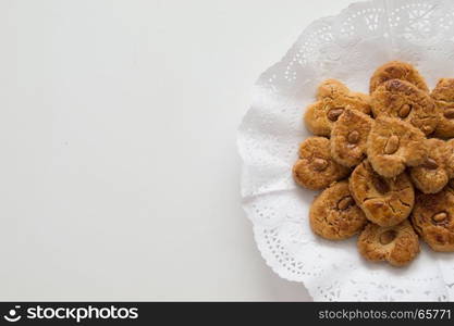 Traditional cookies presented in a tray on the right side. Traditional cookies with almond presented in a tray on the right side