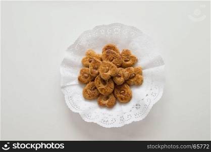 Traditional cookies presented in a tray on white background.jpg. Traditional cookies with almond presented in a tray on white background.jpg
