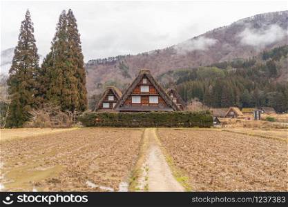 Traditional cottage houses in Shirakawago village with mountain hills in travel trip and holidays vacation in sunmer season, Gifu, Japan. Architecture landscape background. World heritage