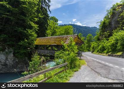 Traditional Covered Wood Bridge in mountain Switzerland