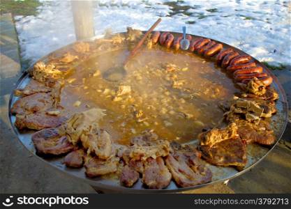 Traditional croatian dish - kotlovina plate cooking