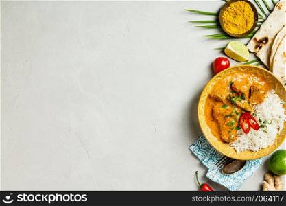 Traditional curry with rice and ingredients on concrete background. Traditional curry, flat lay