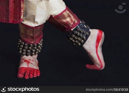 Traditional dancer&rsquo;s feet performing Bharatanatyam on black background