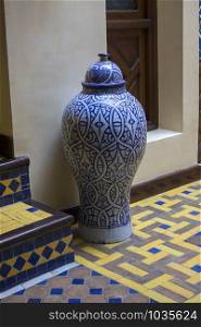 Traditional decorated Moroccan vase in a hall with colorful tiles