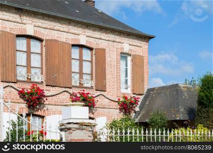 Traditional decorative flowers on around house in Normandy, France