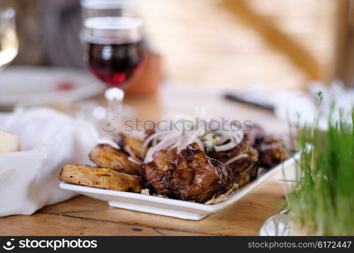 Traditional delicious kebab with onion and glass of wine