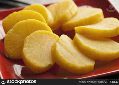 Traditional dish with sliced yellow Japanese pickled radish