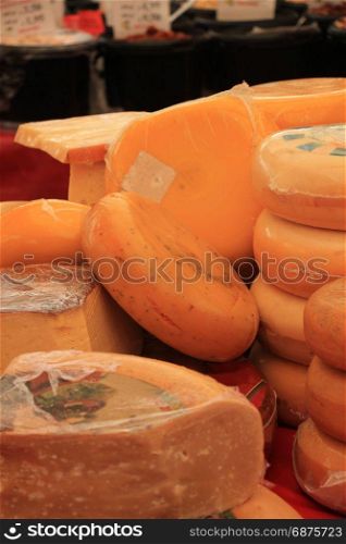 Traditional Dutch cheeses on display on a market stall