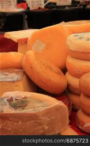 Traditional Dutch cheeses on display on a market stall
