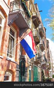 Traditional dutch house decorated with the national flag on Kingsday in Amsterdam the Netherlands