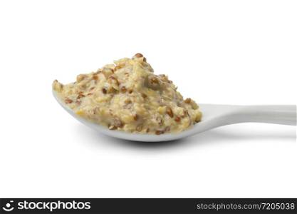 Traditional Dutch mustard on a white spoon isolated on white background