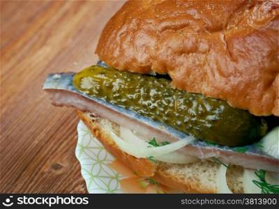 Traditional Dutch sandwich with marinated herring and cucumbers