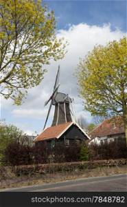 Traditional Dutch wooden windmill in a local farm